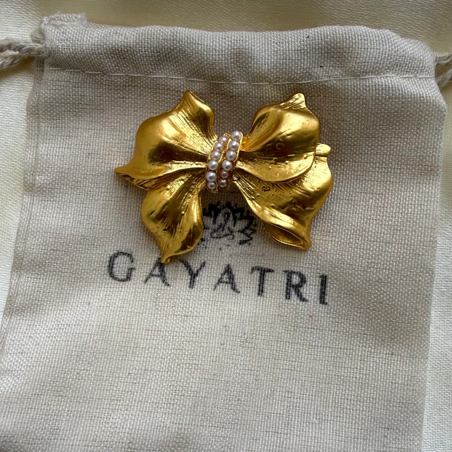 Golden bow brooch